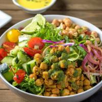 Chickpea Chana · Chickpeas simmered in an Indian spice blend, served over a bed of fresh cut salad (romaine &...