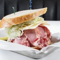 Front Page Special · Hot corned beef with coleslaw, melted Swiss cheese and Russian dressing on rye.