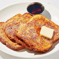 French Toast · Four slices of thick, egg-washed cinnamon bread served with maple syrup.