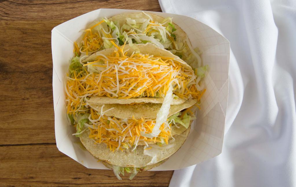 Tacos (4) · Four hard shell tacos ground beef, lettuce, and shredded cheese.