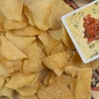 Tavern Espinaca · Zesty, white cheese and spinach dip served with fresh tortilla chips