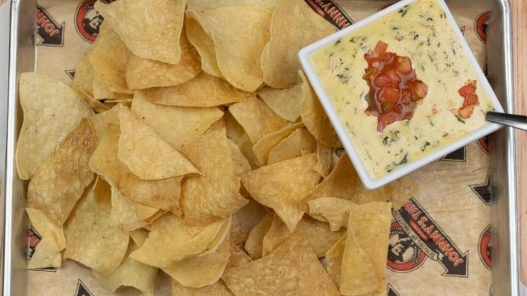 Tavern Espinaca · Zesty, white cheese and spinach dip served with fresh tortilla chips