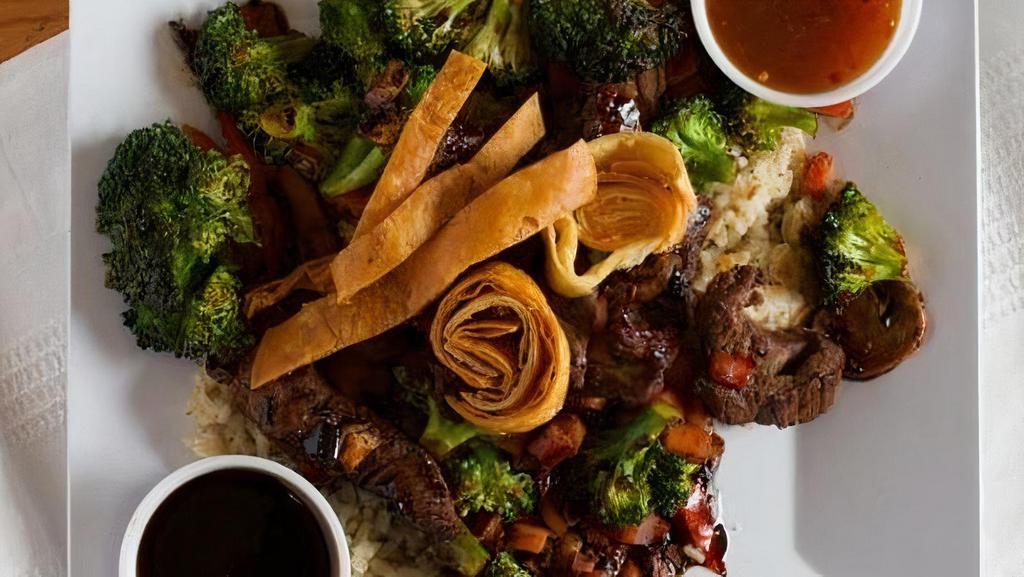 Teriyaki Stir Fry · Broccoli, carrots, mushrooms and red peppers stir fried in teriyaki sesame, served over brown rice and topped with crispy fried strips.