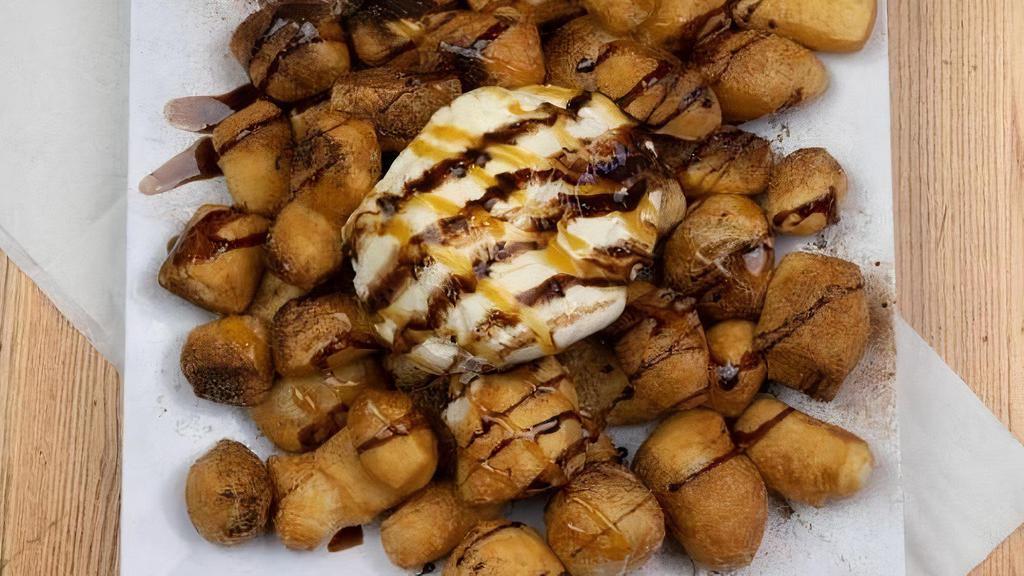 Extra Points · We cut our freshly made dough in to triangles and fry to a golden brown.  Topped with cinnamon sugar, caramel, chocolate and served with ice cream.  The perfect finish to any meal.