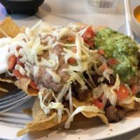 Nachos Locos · Tortilla chips, ground beef, nacho cheese, lettuce, tomato, sour cream, guacamole, beans and...