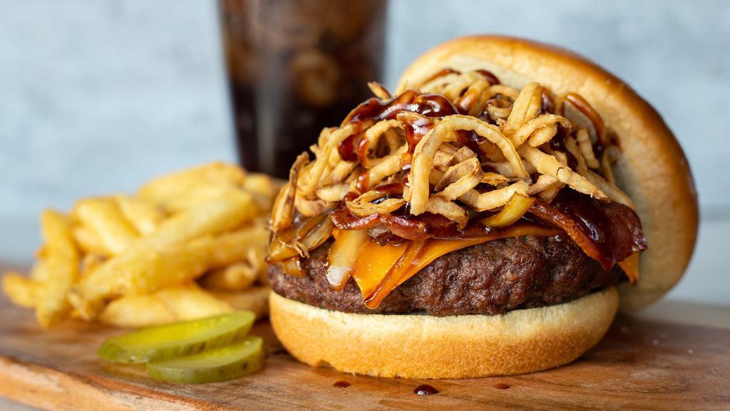 Cola Bbq Bacon · Cheddar, caramelized cherry cola onions, smoked bacon, crispy onion straws and drizzled with cherry cola bbq sauce. Served on a toasted brioche bun.