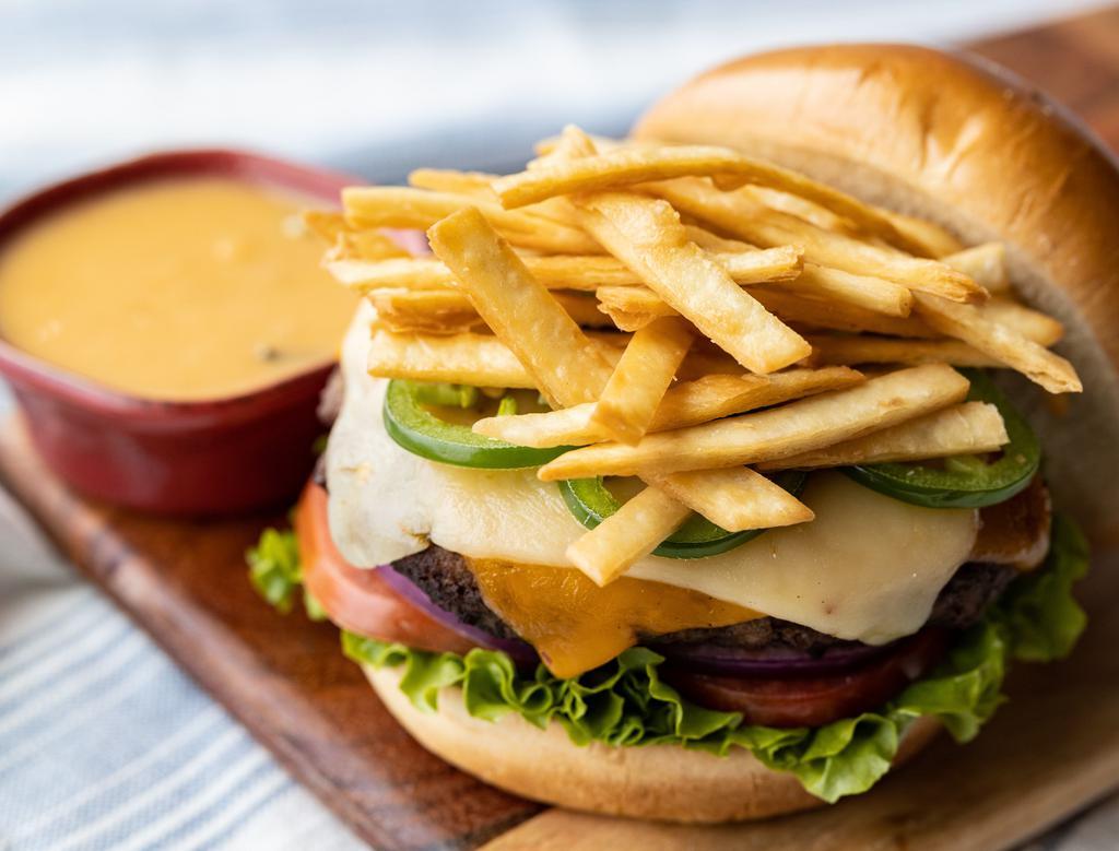 Tortilla · Our signature soup turned burger with cheddar and Pepper Jack, jalapeños and tortilla strips. Served with lettuce, tomato and onion on a toasted brioche bun with a small side of our award-winning tortilla soup for dunking.