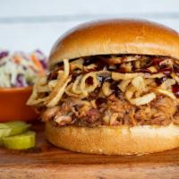 Bbq Pulled Pork · Slow-smoked pork tossed in BBQ sauce, piled high with crispy onion straws on a brioche bun &...