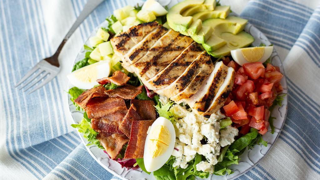 Avocado Cobb · Lemon-rosemary grilled chicken breast on a bed of crisp greens with fresh tomato, cucumber, hard-boiled egg, bleu cheese, smoked bacon and fresh avocado. Served with sweet chili-lime vinaigrette.