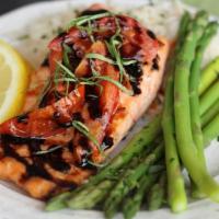 Herb-Grilled Salmon · Flame-broiled salmon finished with lemon-herb glaze & topped with oven-roasted tomatoes, fre...