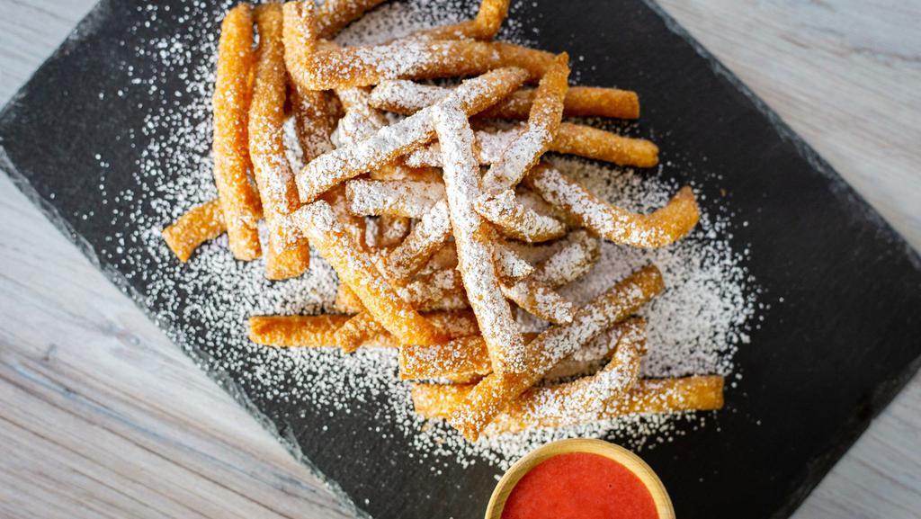 Funnel Fries · Tasty, deep-fried funnel cake fries dusted with powdered sugar & served with a side of strawberry sauce.