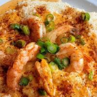 Shrimp & Grits · Buttery creamy grits topped with pan seared Cajun shrimp.