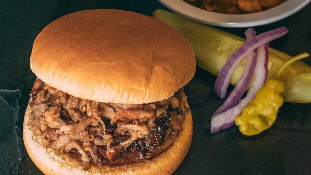 Pulled Pork Sandwich · A hearty helping of our slow-smoked pulled pork served on soft, fresh sandwich bun. Includes 1 of our delicious sides, pickle, pepper, onion & our famous BBQ sauce.