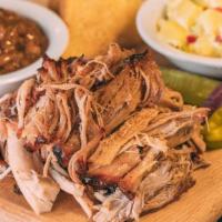 Pulled Pork Dinner · Includes our slow-smoked pulled pork, 2 of our delicious sides, pickle, pepper, onion & our ...