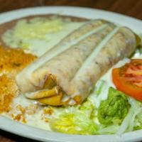 Steak Chimichanga · A steak chimichanga topped with cheese sauce, garnished with lettuce, tomato, sour cream and...