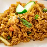 Kow Pad · Thai style fried rice with eggs, onions, green peas and carrots.