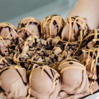Mud Puddle Pie · Vanilla custard blended with peanut butter, peanut buttercups, and hot fudge. Topped with cr...