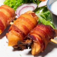 Chicken Brochettes · Bacon-wrapped chicken and artichoke hearts
