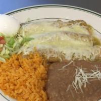 Enchiladas Suizas De Pollo · Three rolled up corn tortillas stuffed with chicken, topped with green tomatillo sauce and s...