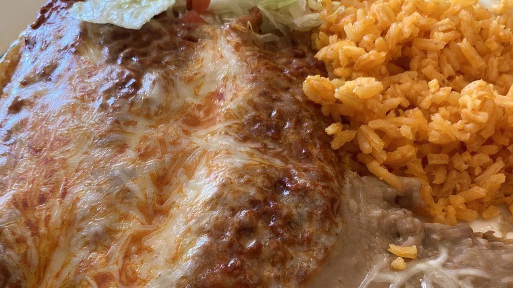 Enchiladas Rojas De Queso · Three rolled up tortillas stuffed with cheese, topped with homemade red sauce and sour cream.