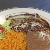 Enchiladas De Mole Poblano · Three rolled up tortillas stuffed with shredded chicken and topped with our delicious mole s...