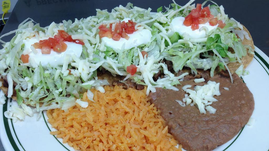 Tostadas Dinner · Three open face tacos topped with beans, lettuce, tomatoes, cheese, sour cream, with your choice of ground beef, chicken, or al pastor.