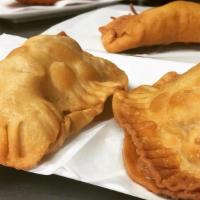 Empanadillas De Mariscos · Seafood turnovers – add cheese for an additional charge.