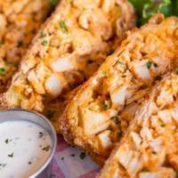 Buffalo Rolls · Grilled buffalo chicken breast, shredded monterey jack & blue cheese cheese, wrapped in a cr...