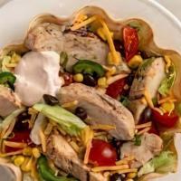 Grilled Chicken Taco Salad · Crispy flour shell filled with grilled chicken breast, lettuce, cheese, and tomato with sour...