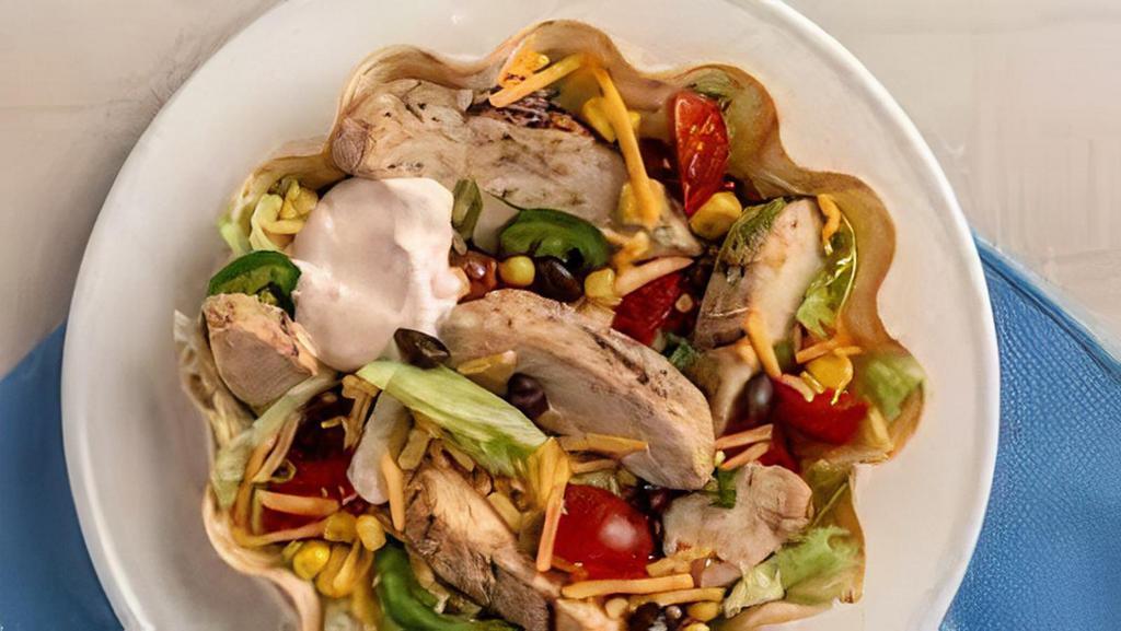 Grilled Chicken Taco Salad · Crispy flour shell filled with grilled chicken breast, lettuce, cheese, and tomato with sour cream on the side. Served with rice and beans.