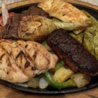 Parrillada · The ultimate skillet. A combination of grilled steak, grilled chicken breast, chorizo, and g...