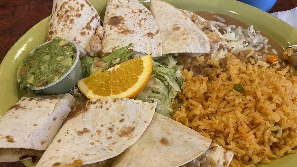 Quesadilla De Camarones · Flavorful shrimp and cheese. Served with Spanish rice, refried beans, and guacamole.
