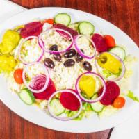 Greek Salad · Tomatoes, onions, cucumbers, olives, beets, pepperoncini, feta cheese and Greek dressing.