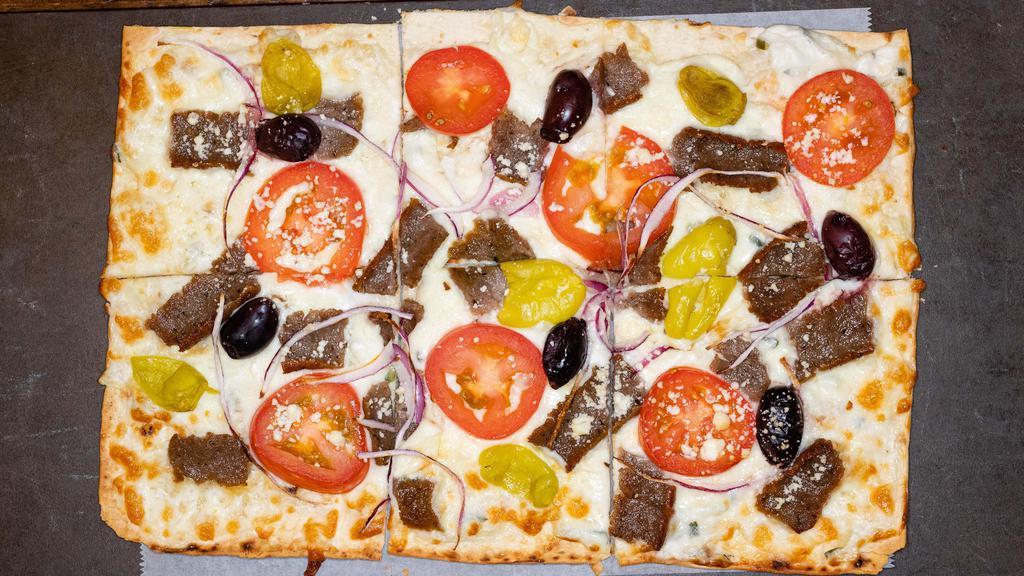 Greek Flatbread · Tzatziki sauce, gyros meat, tomato, onion, kalamata olives, feta and mozzarella cheese on lavash bread.