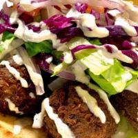 Falafel Sandwich · Vegan. Chickpeas, onions, parsley, garlic and spices. Deep fried and served in fresh pita br...