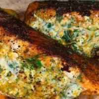 Stuffed Salmon · Lemon and garlic sautéed salmon - stuffed with a six cheese spinach on a bed of roasted garl...