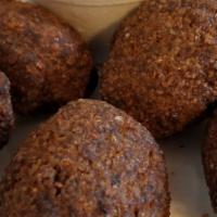 Kibbeh Ball (2) · Ground beef, cracked wheat, stuffed with almonds in center.