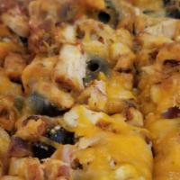 Chicken Pizza · Our famous gyro sauce, tomatoes, olives, onions, feta, mixed cheeses, grilled chicken, and z...