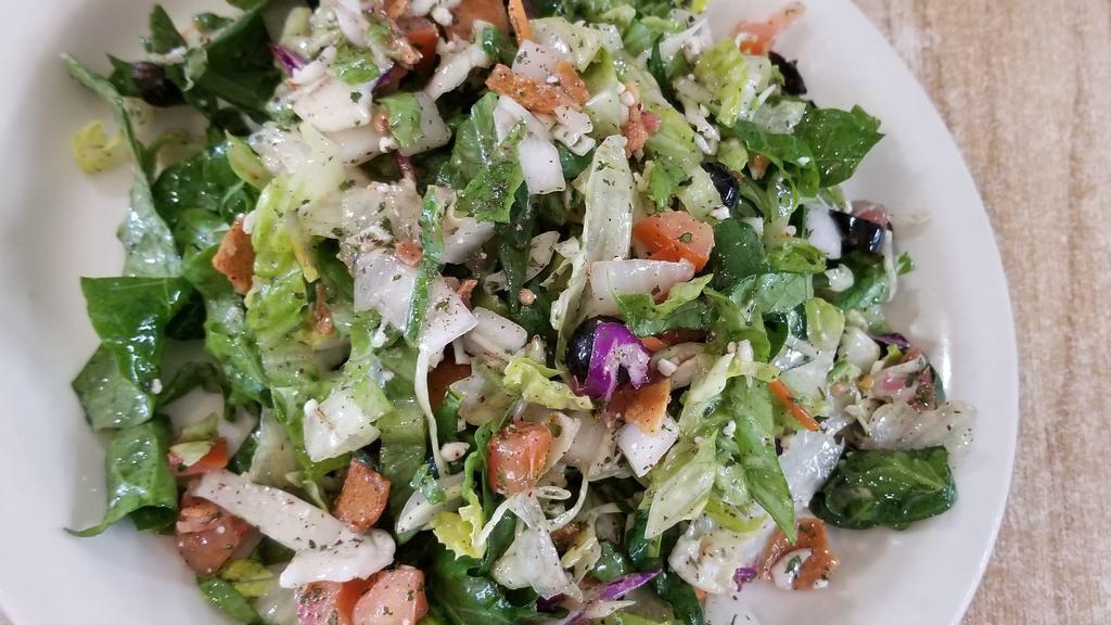  Fattoush Salad · Chopped romaine Lettuce, onions, tomatoes, olives, feta, crunchy pita chips with our homemade vinaigrette dressing.
