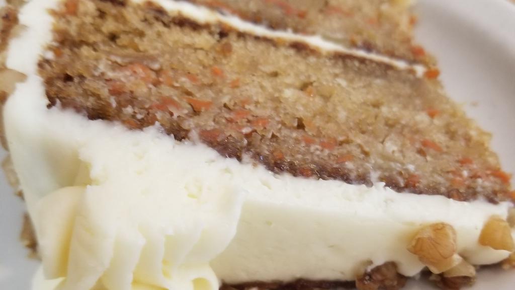 Carrot Cake · Homemade carrot cake, sprinkled walnuts with a buttercream icing..