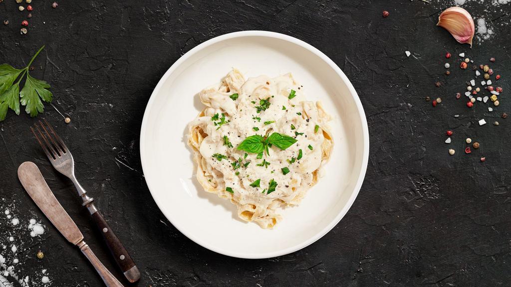 Alfredo Pasta (Fettuccine) · Fettuccine pasta cooked al dente tossed in creamy white sauce topped aged parmesan. Served with bread.