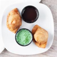 Vegetable Samosa (2 Pc) · Deep fried crisp pastries stuffed with mildly spiced potatoes and green peas.