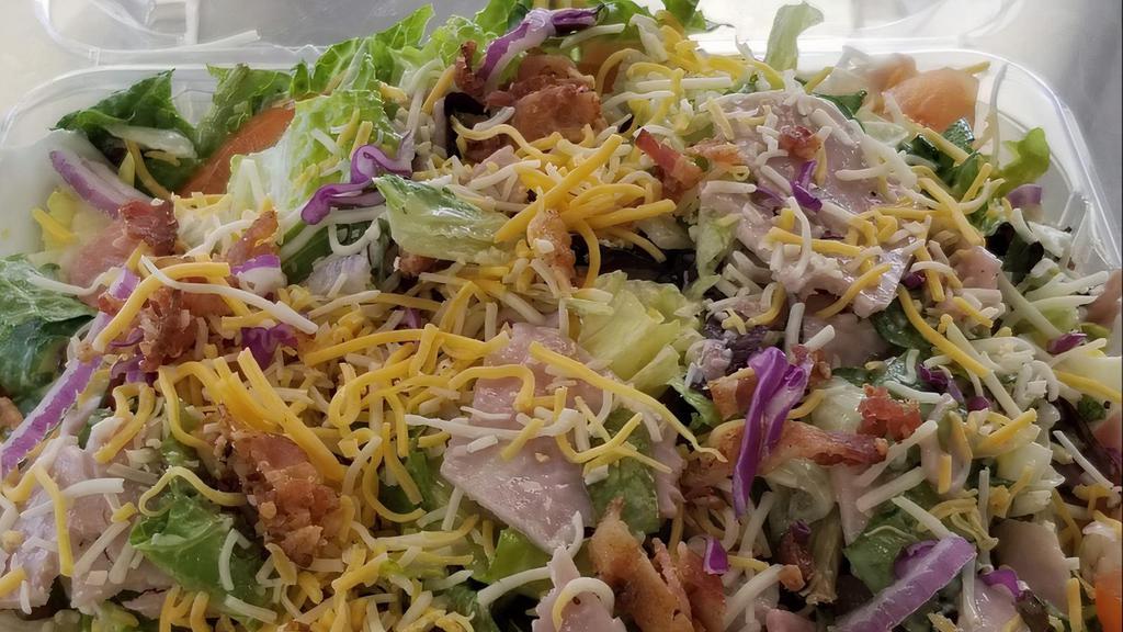 Big Time House Salad · Ham, bacon, tomato, onion, cucumber, egg,  shredded blend of cheese, tossed in a poppy seed dressing.