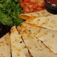Chicken Quesadilla · Cajun grilled chicken with cheddar cheese and bacon grilled between a flour tortilla shell.
