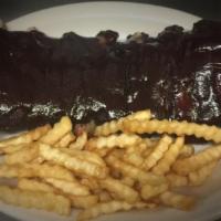 Bbq Ribs · Pork loin back ribs smoked in house over hickory wood chips and glazed with BBQ sauce.