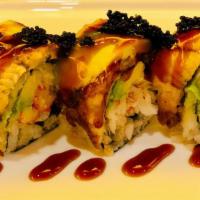 Black Dragon Roll · Blue crab, avocado, and cucumber inside, eel, avocado, and black tobiko, and eel sauce on top.