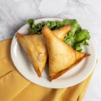 Sambusa · thin dough shells are stuffed with a balanced blend of minced chicken, green chili and herbs...