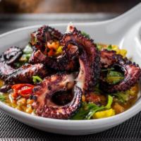 Charred Octopus · Served with pepperoncini, chickpeas, lemon, and heirloom tomatoes.