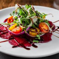 Roasted Beets · Served with Gorgonzola, almonds, and wild greens.