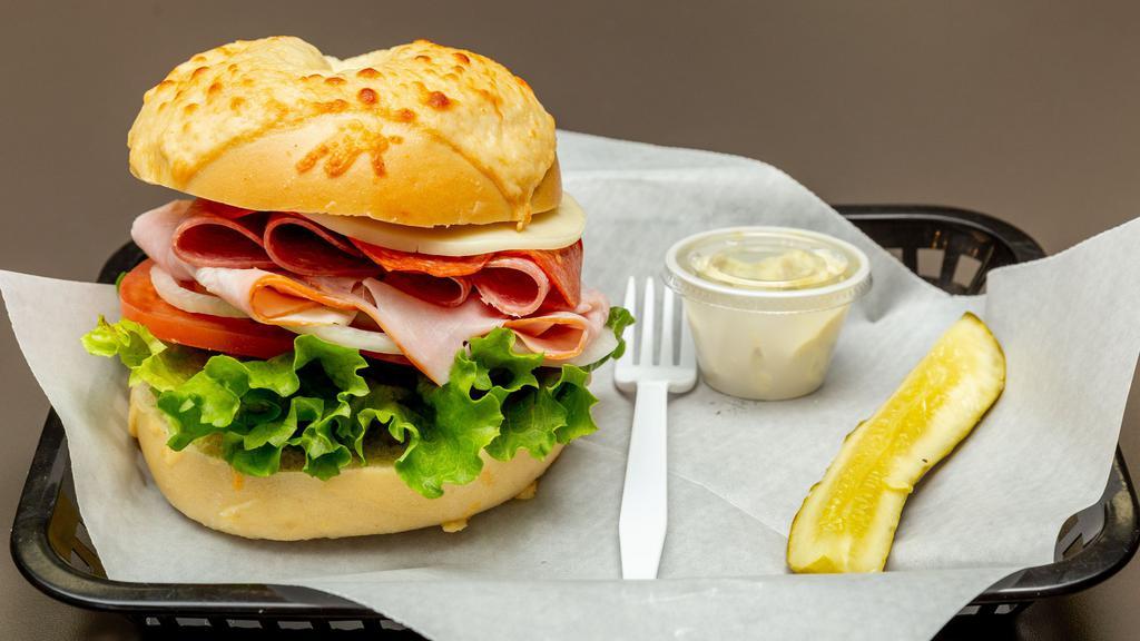 Italian Trio On · Ham, salami, pepperoni, provolone cheese, lettuce, tomato, onion, and Italian dressing served on an Asiago bagel.